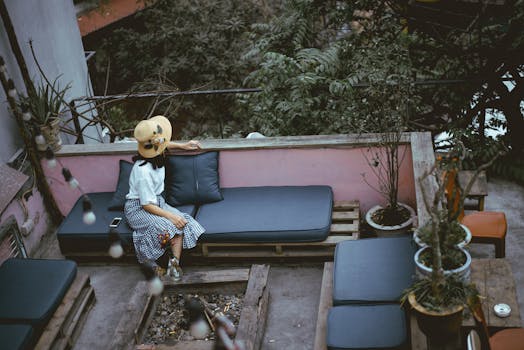 A cozy urban garden with seating and plants