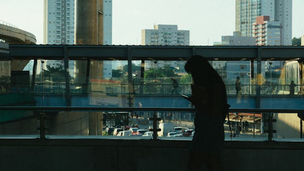 image of a city skyline with people using mobile devices