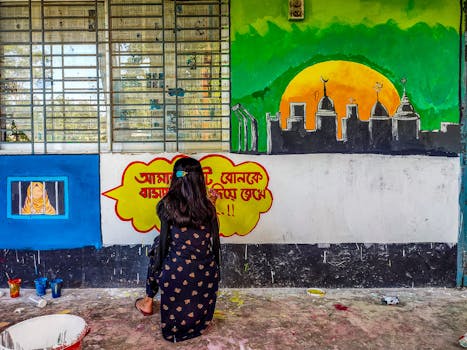 A young artist painting a mural