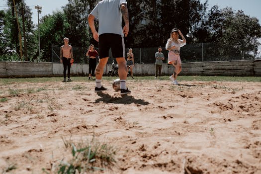 group of friends playing soccer in a park