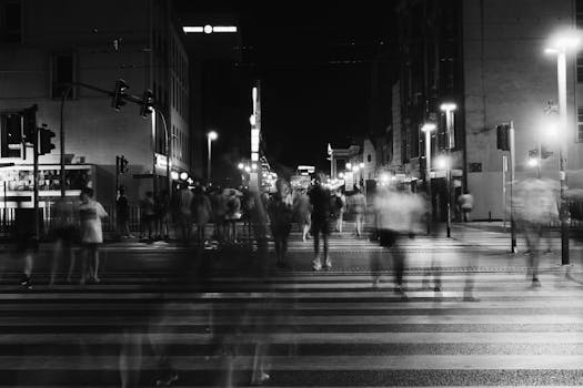 Busy city street lit at night