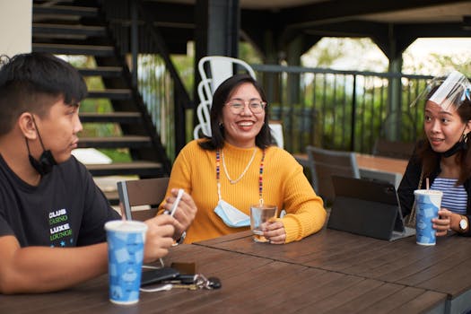 group of friends laughing in a coffee shop